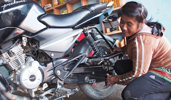 Kamala in her motorcycle repair shop