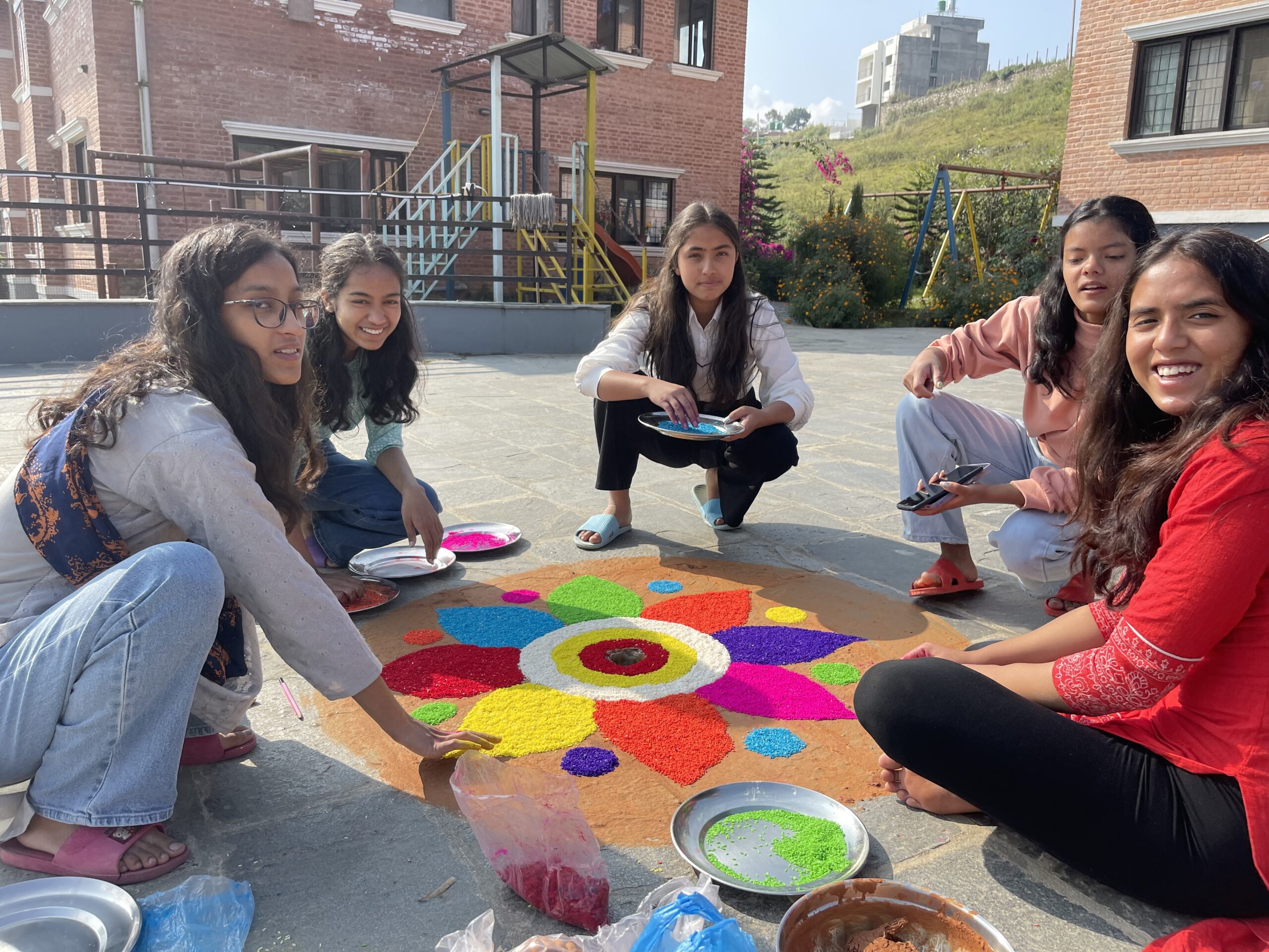 It's tradition for some of the Olgapuri kids to perfect a colorful sand mandala in the courtyard before the Bhai Tika ceremony begins.