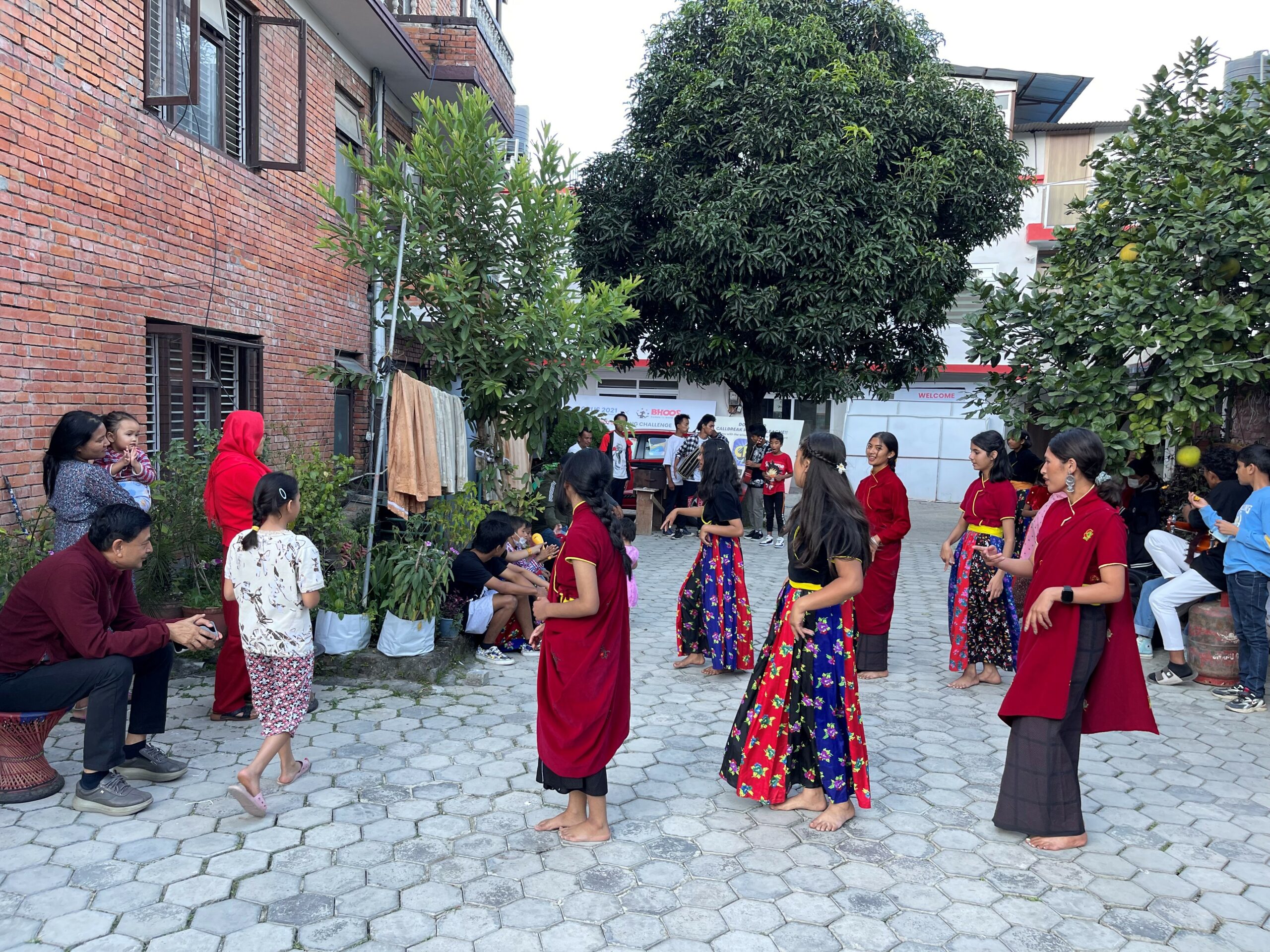 Junior girls wear traditional Nepali clothing and dance for their Deusi-Bhailo performance